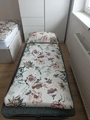 a bed in a room with a blanket on the floor at CoCo Apartment in Ljubljana