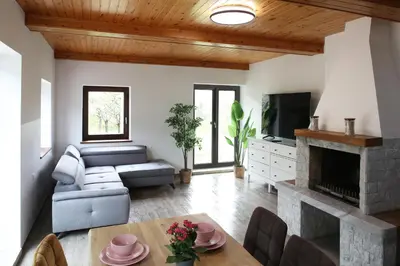 a living room with a couch and a fireplace at Sunset Valley Apartments and Rooms in Bohinj