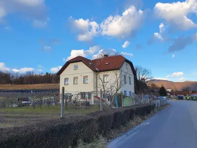 a white house with a red roof on the side of a road at Gala Lenassi in Kamnik