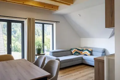 a living room with a couch and a table at Family and Friends Apartments Bled in Spodnje Gorje