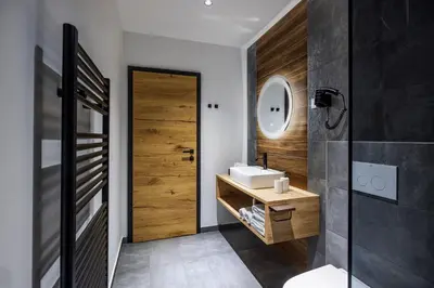 a bathroom with a sink and a mirror at Family and Friends Apartments Bled in Spodnje Gorje