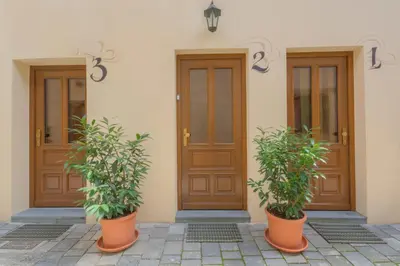 two potted plants sitting in front of a building at Old Town ground floor in Ljubljana