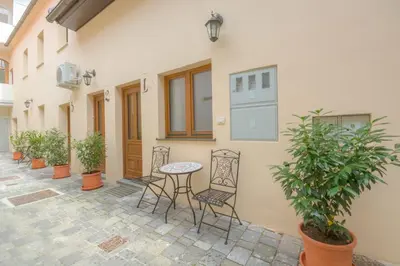 a patio with a table and chairs next to a building at Old Town ground floor in Ljubljana