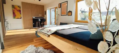 a bedroom with a bed with a wooden headboard at Biohacker Ljubljana in Ljubljana