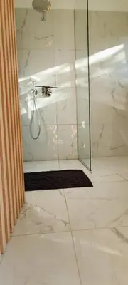 a bathroom with a shower with a glass door at Biohacker Ljubljana in Ljubljana