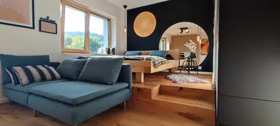 a living room with a couch and a mirror at Biohacker Ljubljana in Ljubljana