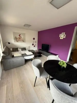 a living room with a couch and a table and chairs at My Family Home Bled in Bled