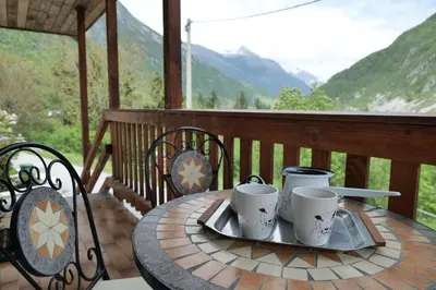 a table on a porch with mugs on it at Chalet Julian in Žaga