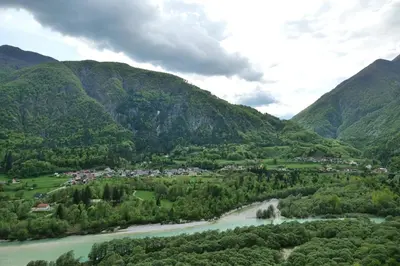 a village in a valley with a river and mountains at Chalet Julian in Žaga