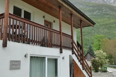 a house with a balcony with wooden railing at Chalet Julian in Žaga