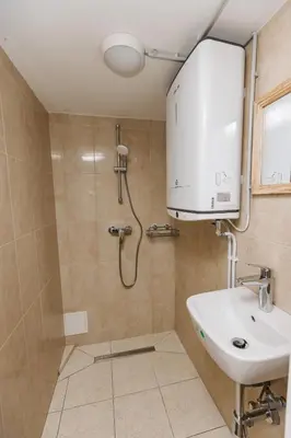 a bathroom with a sink and a shower at Komac Apartma & Glamping BLED in Bled
