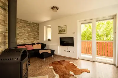 a living room with a dog laying on the floor at Bee Apartment in Bohinj