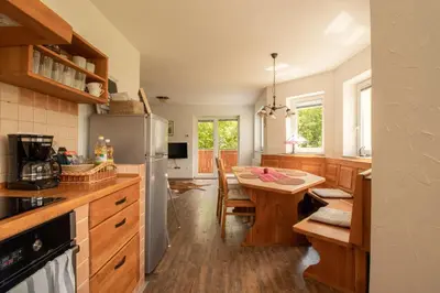 a kitchen with a table and a refrigerator at Bee Apartment in Bohinj