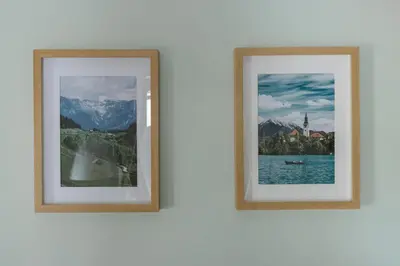 two framed photographs hanging on a white wall at Castle Road Bled in Bled