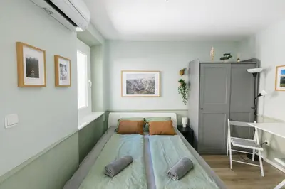 a small bedroom with a bed in the corner at Castle Road Bled in Bled