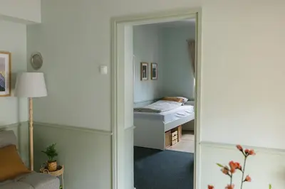 a bedroom with a bed and a mirror at Castle Road Bled in Bled