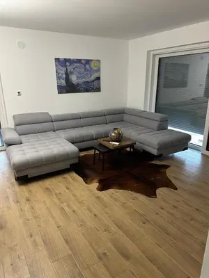 a living room with a couch and a table at Villa AMULET in Postojna