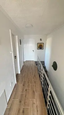 an empty hallway with a wooden floor in a building at Villa AMULET in Postojna