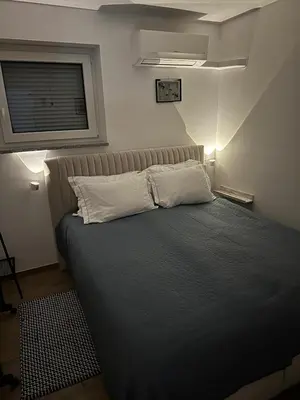 a bedroom with a bed with a pillow and a window at Villa AMULET in Postojna