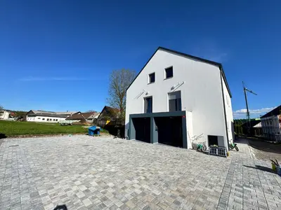 a large white building with a large driveway at Villa AMULET in Postojna