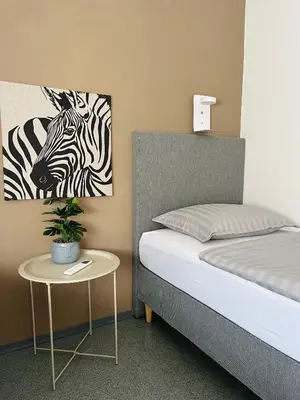 a bedroom with a bed and a picture of a zebra at Hostel POINT Nova Gorica, Self Check-In with code access in Nova Gorica
