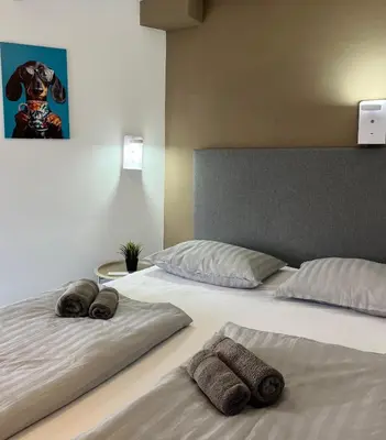 a bedroom with two beds with towels on them at Hostel POINT Nova Gorica, Self Check-In with code access in Nova Gorica