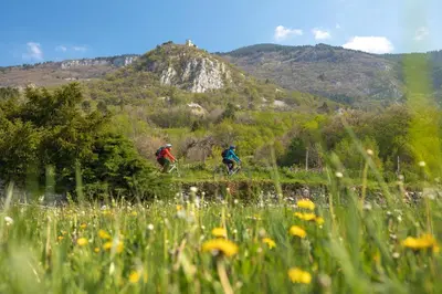 two people riding bikes in a field of flowers at Hostel POINT Nova Gorica, Self Check-In with code access in Nova Gorica