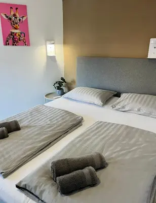 two beds sitting next to each other in a room at Hostel POINT Nova Gorica, Self Check-In with code access in Nova Gorica