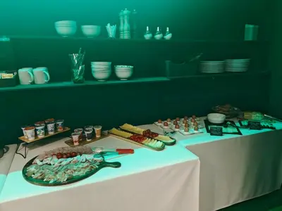 a table with a plate of food on it at Hostel POINT Nova Gorica, Self Check-In with code access in Nova Gorica