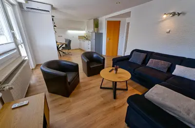 a living room with a couch and chairs and a table at Apartma Storžič in Preddvor