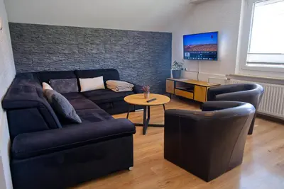a living room with a couch and a table at Apartma Storžič in Preddvor
