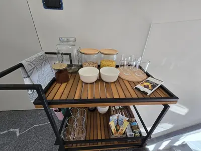 a table with food and jars on top of it at Nova Nest from Granite Getaways in Nova Gorica