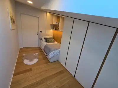 a small bedroom with a bed and a mirror at Nova Nest from Granite Getaways in Nova Gorica