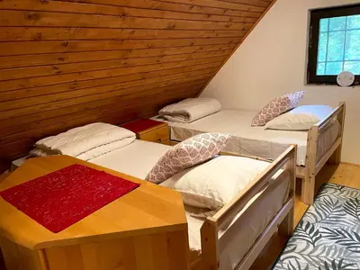 a room with three bunk beds in a cabin at Chalet Vogar in Bohinj