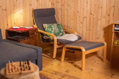 a living room with a chair and a chess board at Chalet Vogar in Bohinj
