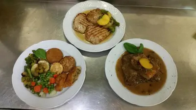 three plates of food sitting on a table at Gostilna Stara Pošta in Pucaie