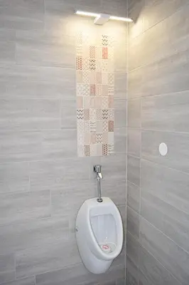 a bathroom with a urinal on a wall at Grajski kamp - pitch your own tent in Kočevje