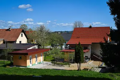 a group of houses with red roofs at Grajski kamp - pitch your own tent in Kočevje