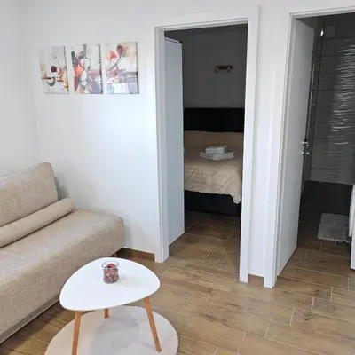a living room with a couch and a table at Stars Apartments in nature in Postojna