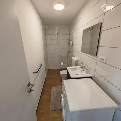 a white bathroom with a sink and a toilet at Stars Apartments in nature in Postojna