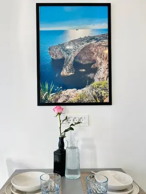 a picture hanging on a wall above a table with plates at St Mountain Escape in Žirovnica
