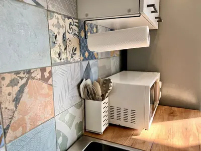 a small kitchen with a microwave and a counter at St Mountain Escape in Žirovnica