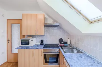 a kitchen with a sink and a microwave at Apartment Gaspercic in Bovec