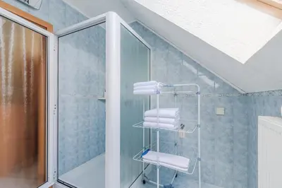 a bathroom with a shower and some towels at Apartment Gaspercic in Bovec