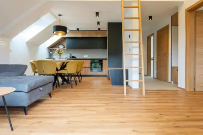 a living room with a blue couch and a ladder at Apartment Tanja 3 Bedroom, Mountain View & Family Stay in Golnik