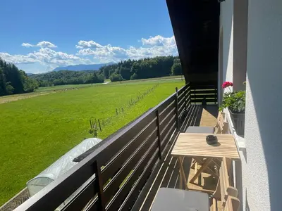 a balcony with a table and a view of a field at Apartment Tanja 3 Bedroom, Mountain View & Family Stay in Golnik