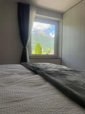 a bedroom with a bed with a large window at Apartment Tanja 3 Bedroom, Mountain View & Family Stay in Golnik