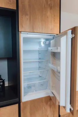an empty refrigerator with its door open in a kitchen at Apartment Tanja 3 Bedroom, Mountain View & Family Stay in Golnik