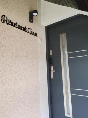 a front door of a building with a sign on it at Apartment Tanja 3 Bedroom, Mountain View & Family Stay in Golnik