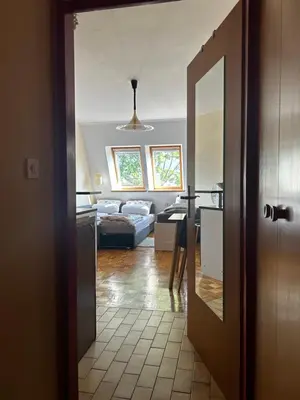 a open door to a living room with a couch at Apartma Giorgo in Bovec